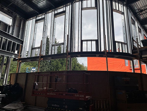 a metal framed wall with window holes