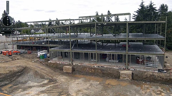 a three story structure under construction with just steel beams