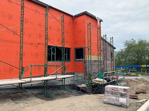 a building with scaffolding and partial brick walls