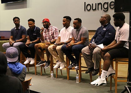 A group of students and mentors in a panel discussion
