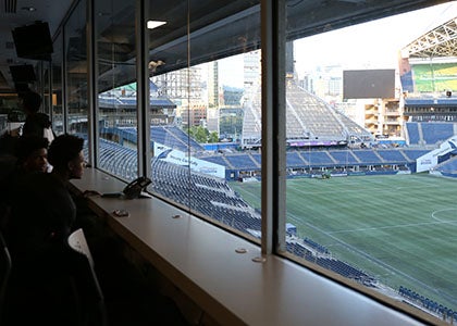 Students in the Lumen press box