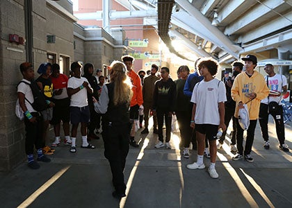 Students listen to a tour guide at Lumen Field