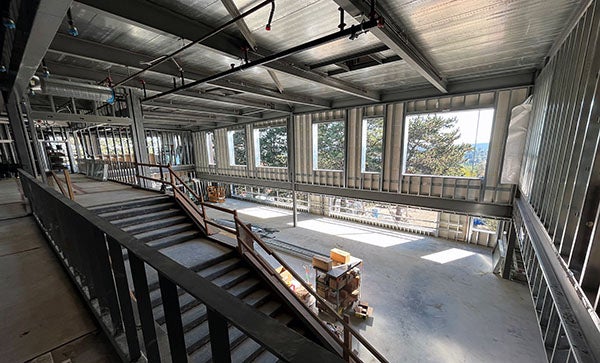 a large room under construction with high ceilings and window holes
