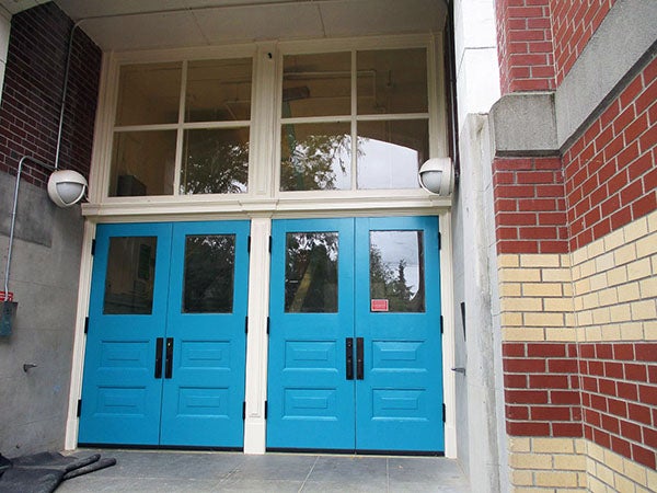 two double blue doors with windows above