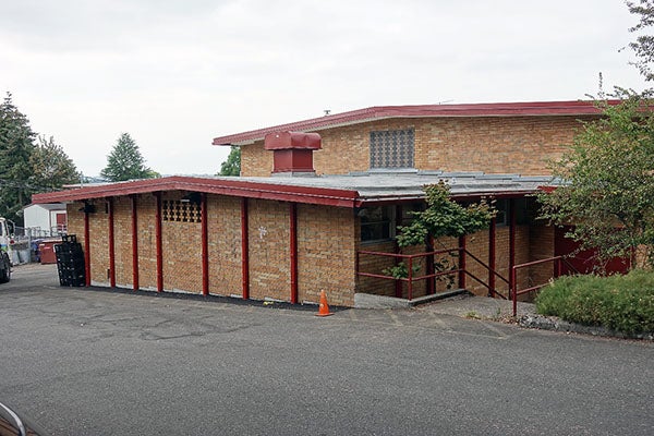 painted steel supports on a brick building