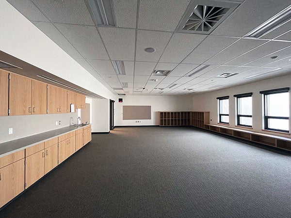 a large empty room with cabinets