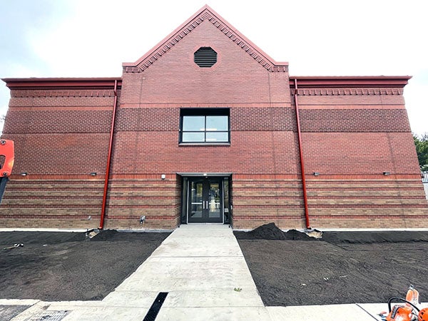 a 2-story building with brick exterior and a door in the center