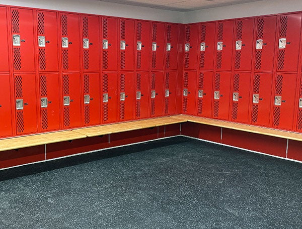 red lockers with a bench in front
