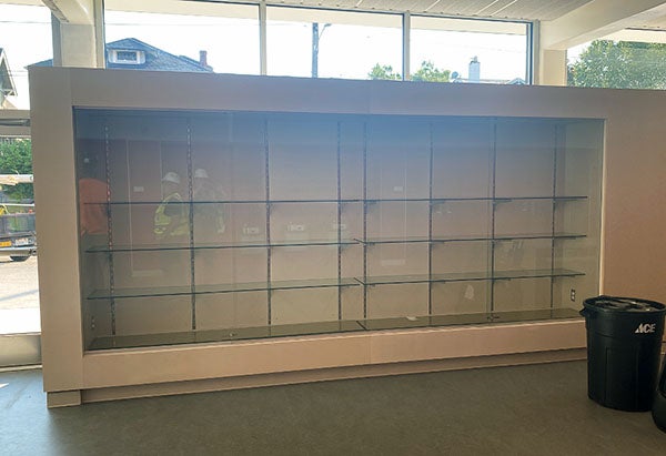 an empty trophy case with windows behind it