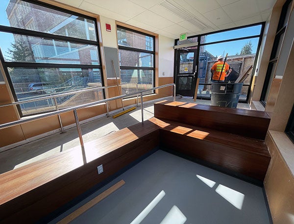 wood benches with a concrete ramp and windows