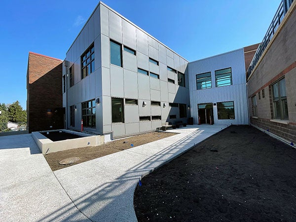 a metal clad wing of a brick building