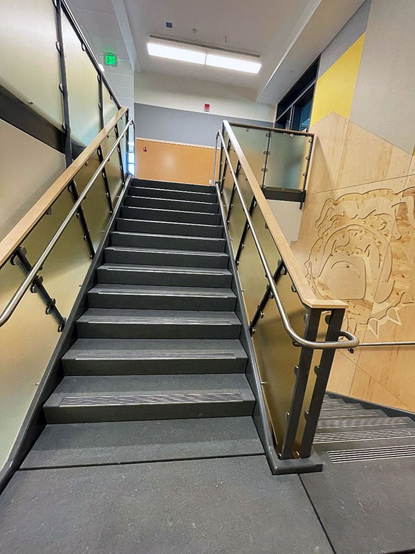 an interior stairway with handrails