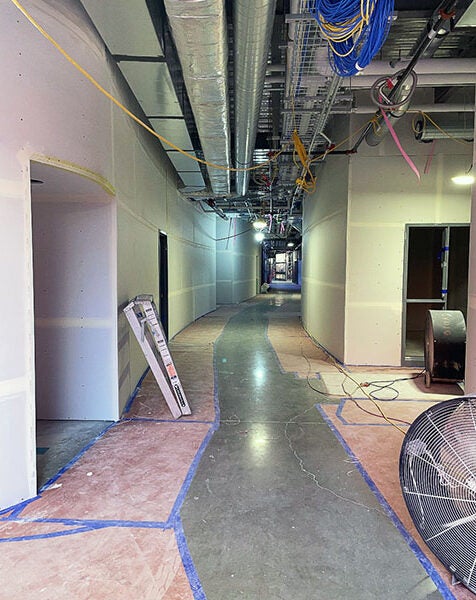 an unfinished corridor in a large building