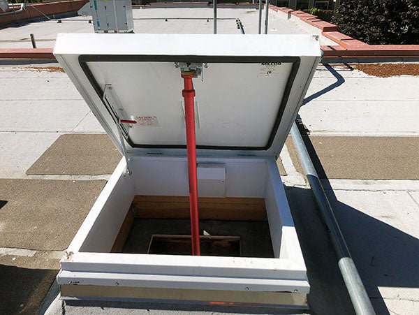 an open roof hatch on a flat roof