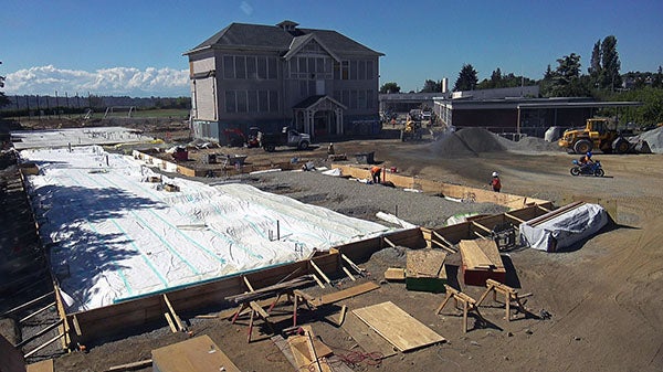 a construction site next to an old two story building