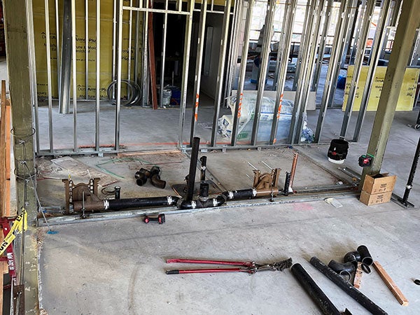 a concrete floor with a metal and steel ceiling and metal wall framing