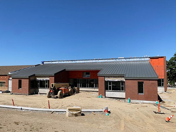a one story building under construction with brick on some of the walls
