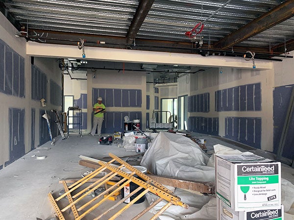a partially built room with a person standing by the wall