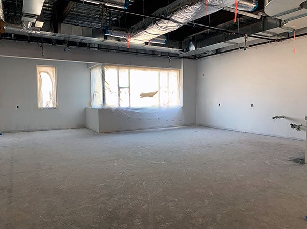 a large room with windows covered in plastic