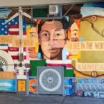 The school mural with people, U.S.A. flag and text 