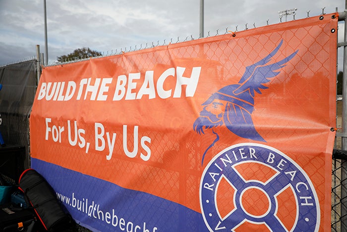 an orange and blue banner that says build the beach for us by us