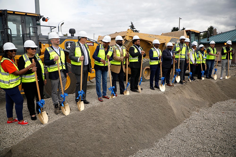 a line of people with shovels