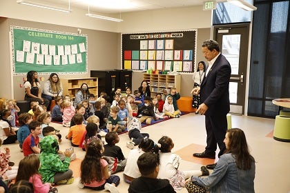 The mayor stands before an assembly of students.