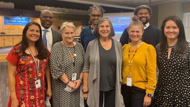 Eleanor Toews stands together with the superintendent and school board