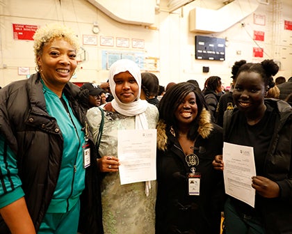 A group of four women stand together at the expo event