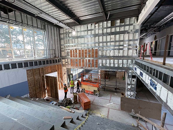 a large open area in an unfinished building with concrete stairs