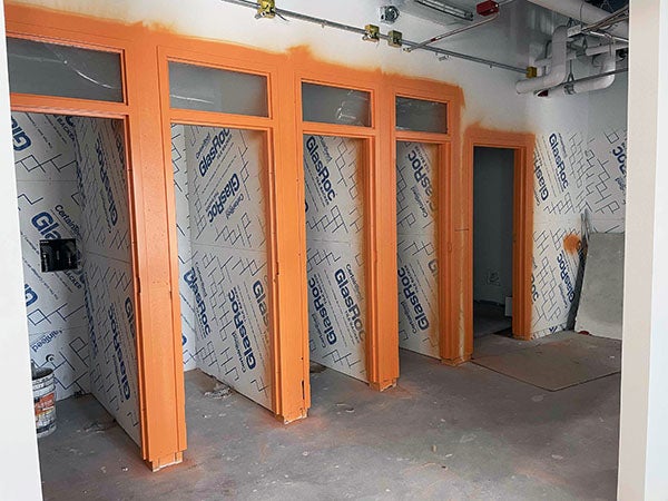 small rooms under construction with painted door frames