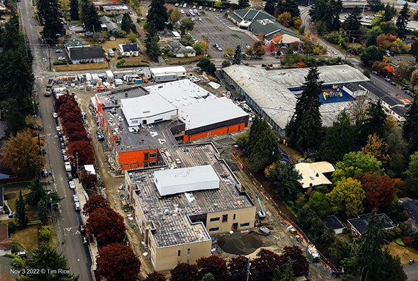 aerial view of a large building under construction with another large building next to it