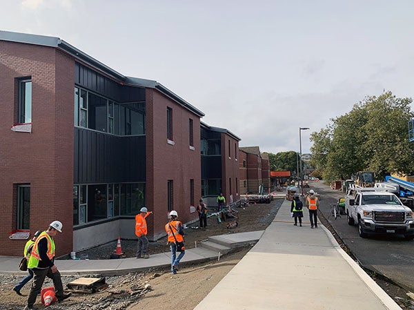 a long brick building with varying faces and construction work happening