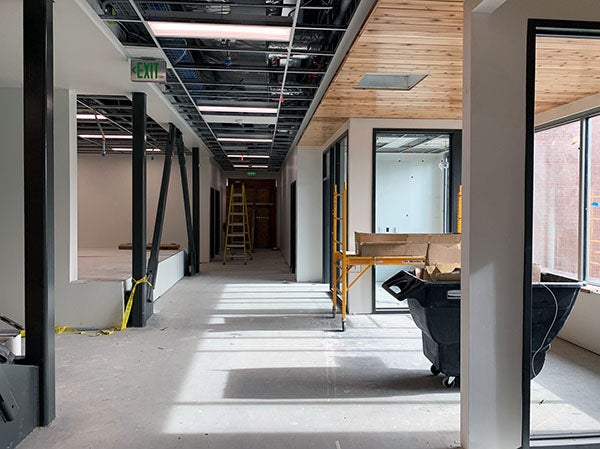 an interior space under construction with a wood ceiling in front of some windows