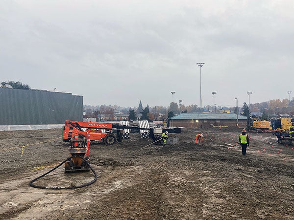 a muddy field with construction equipment