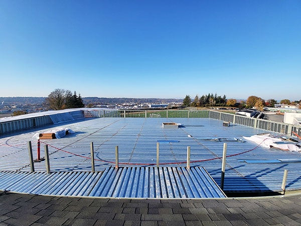 a larg metal roof with a playfield in the distrance