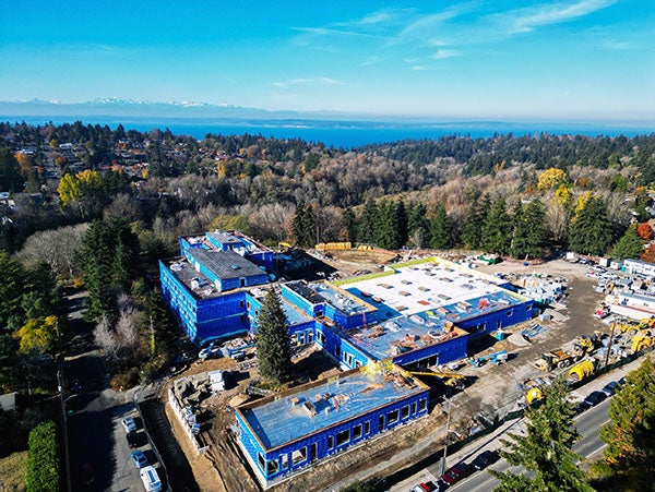 aerial view of a large building with blue walls and flat roofs