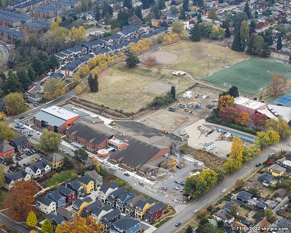 aerial view of a large building with a field behind it