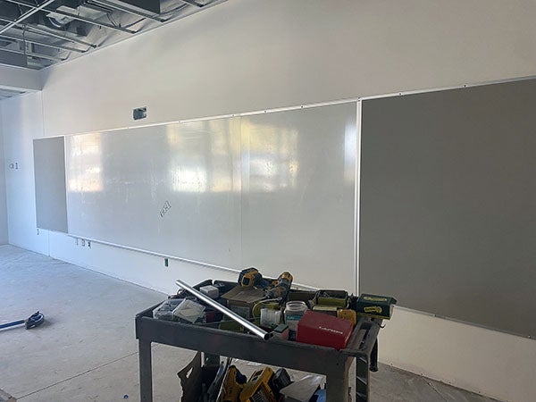 a long wall with a white markerboard