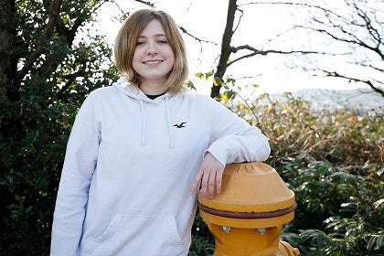 Ireland poses for a photo next to a fire hydrant 