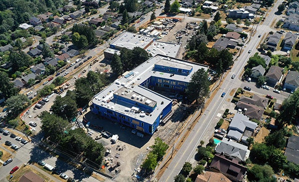 aerial view of a large building with a road in front