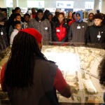 A group of students listens to a Microsoft staff