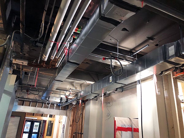 metal ductwork in the ceiling next to large pipes