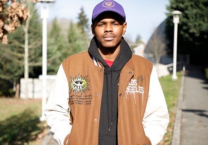 Trevon poses for a photo on a sidewalk