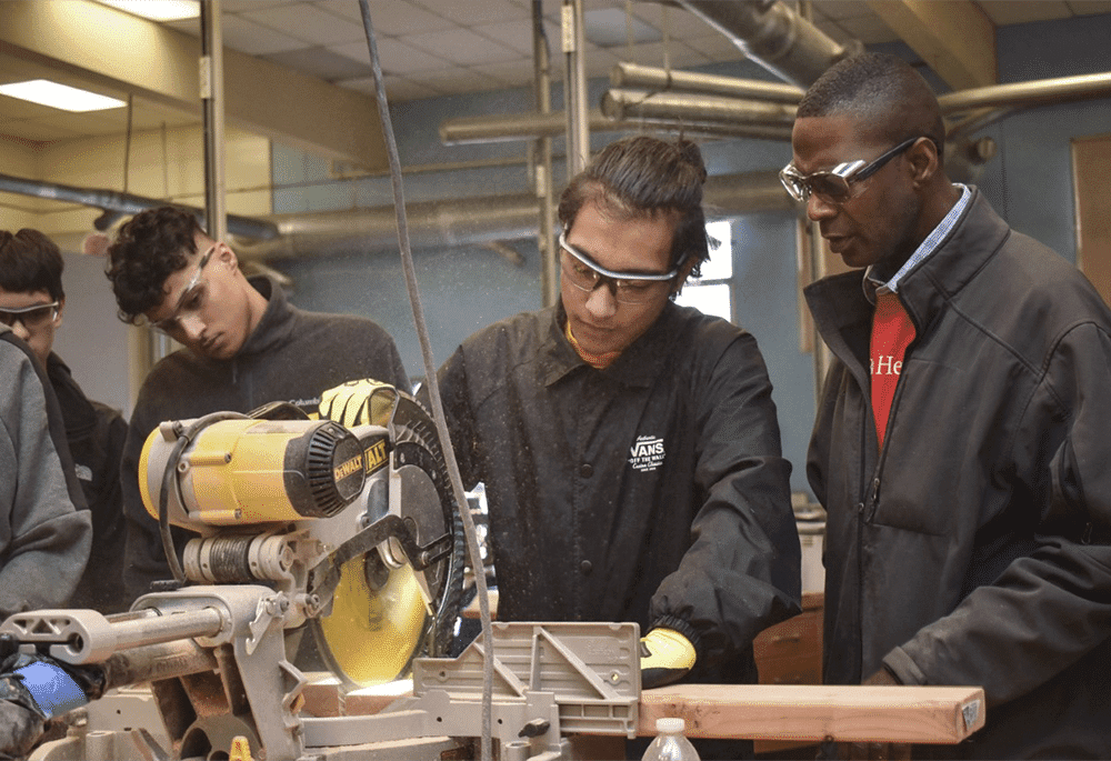 Students and a mentor working in a wood shop