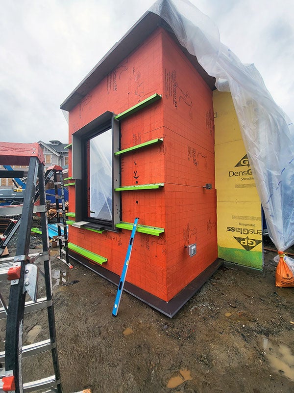 a part of a building with orange material wrapped around it