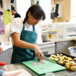 A student in a culinary arts class prepares ingredients