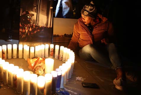 women sitting next to candles in the shape of a heart