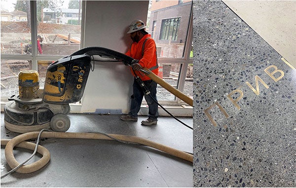a worker uses a floor polishing machine on concrete floor in front of a window