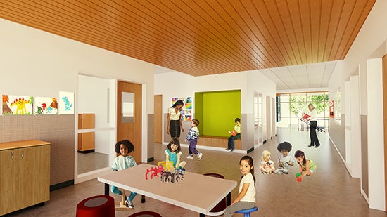 a large space with tables and cabinets and a window into a classroom